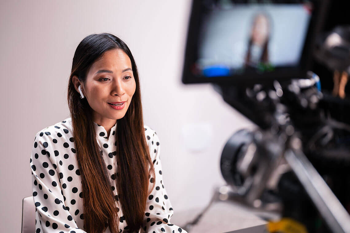 Female in front of camera making a video