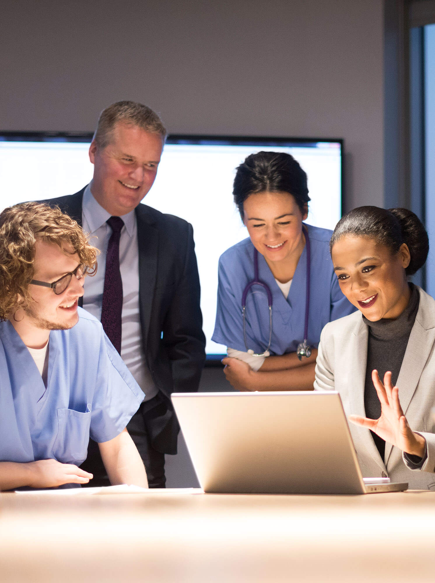 Group of doctors around a laptop